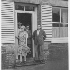 On the steps of The New Inn (now the Izaak Walton), customers keep their feet dry. Note 'Alton Ales'. 