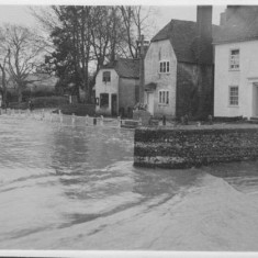 Looking east past the road outside the George Inn, Barnards and Old Bell Cottage on the right.