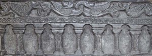 West side. Despite the teaching in the Church that the earth was a sphere, on the west side of the marble the sculptors of Tournai prefer to show the world as flat, resting on a series of pillars and arches and above on the surface of the ground mystical beasts which represented the real-life creatures from the reptiles to the birds, which God had created.