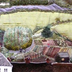 Allotments Fields, roads, hedges and bushes (as in the depiction of the Allotments, above) were embroidered either in situ directly on the calico, or using the same techniques as for the houses, or using materials with stitches applied for extra interest.