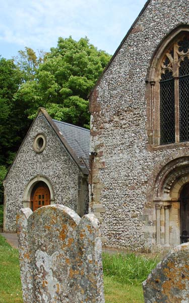 The Church Room, added in 2000. The west doorway of the church is Norman/Romanesque. 