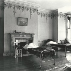 Dormitory at Wesbury House, with original wallpaper from re-building after the fire in 1904.