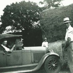 Ernest with George Munday 'sweeping'  hay with car