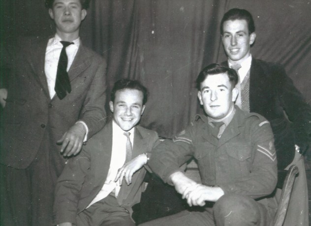 Four young men, one in uniform