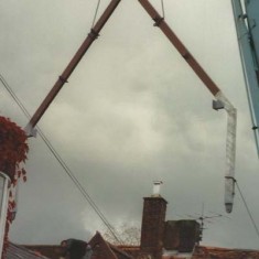 A pillar is lowered into position. 