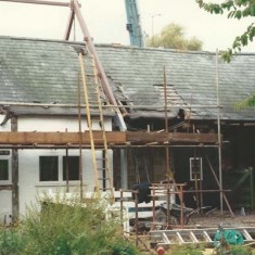 Instaalling extra floor`from the north of The Tudor House, the steel frame being lowered.