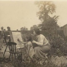 Girl painting in garden Girl painting in garden, mother looking