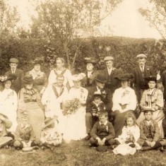 Group photo. Grandfather with John's father on knee Group photo. Grandfather with John's father on knee