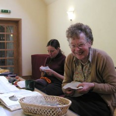 Monique Aldridge and Sylvia Brindley. A team of over 30 embroiderers started work on the tapestry  which was to include 107 houses and the fully embroidered borders which incorporate 26 birds, animals and church features.