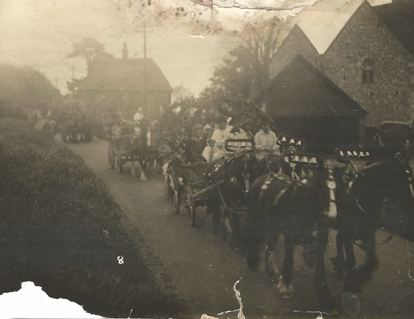 Early photo of procession passing between Court Farm and All Saints.