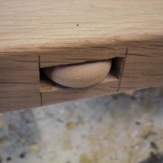 Toy wheels, hidden, to reduce friction of drawer locking mechanism