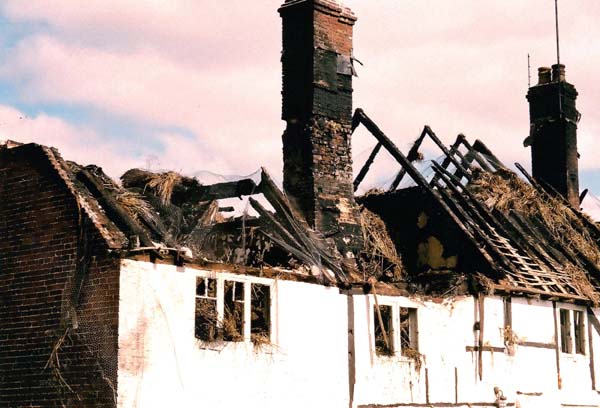 The roof rafters and  one  chimney stack of Hockley Cottage