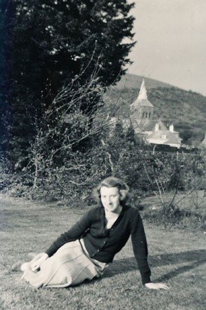 Olivia Woodfield on the lawn at The Tudor House, with a clear view of All Saints' spire behind.