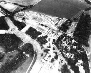 Aerial photograph of the buildings which comprised HMS Mercury. In 1941, Leydene House and 100 acres had been occupied by the Royal Navy, whose Signal School in Portsmouth had suffered from heavy bombing. A Wardroom annex was constructed to the south of the Main House, known as Siberia Block. A large Nissen hut was completed in July 1943 and was used as a cinema, theatre and assembly hall, followed by other training facilities and accommodation.