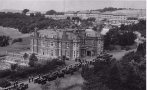 Main house in 1950s, with naval parade taking place in front of it. The first semi-permanent buildings to be constructed commenced in April 1944 and were the classrooms of North Camp.. The Navy requisitioned the property in 1945 and bought Leydene House in 1949. 