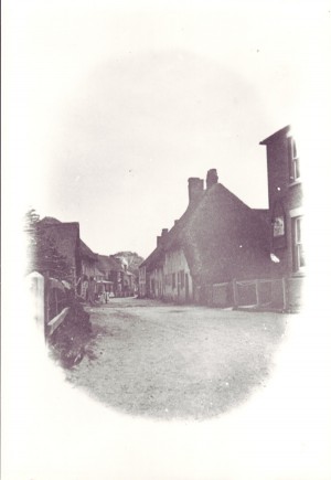 Vignette of High Street. This appears to have been photographed before the 1910 fire which devastated this end of the High Street.