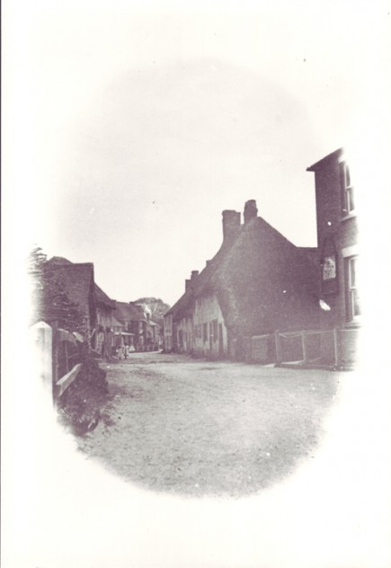Vignette of High Street. This appears to have been photographed before the 1910 fire which devastated this end of the High Street.