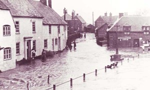 Barnards and War Memorial flooded Hazel Goddard on doorstep Barnards and War Memorial flooded. Hazel Goddard is standing on the doorstep