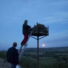 Bill Tyrwhitt Drake about to light the beacon