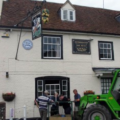 George facade and loader George facade and cherry picker, installing village broadband 2002. The wireless aerial is being attached to the chimney at the George.