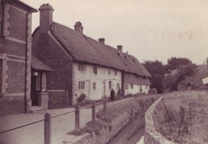 Hockley Cottage and narrow river. Old lady in black.