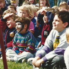 Boys in audience, one with face painting