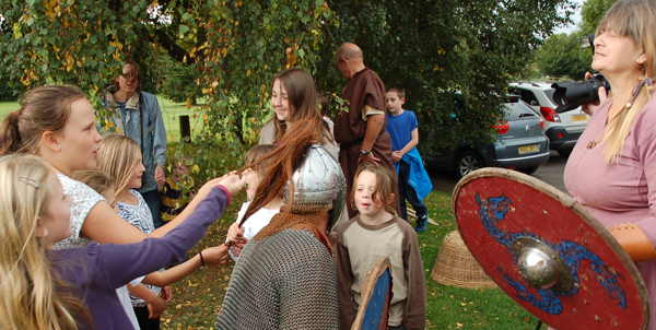 King Harold is briefed by the Saxon re-enactor.