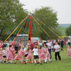 Children from East Meon Church of England Primary School dancing round the Maypole