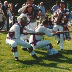 One of the early Country Fairs, the Morris Dancers join in the tug-of-war.