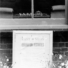 Shop window during Coronation with poster and miniture state coach and horses. Window during Coronation with poster and miniature state coach and horses.