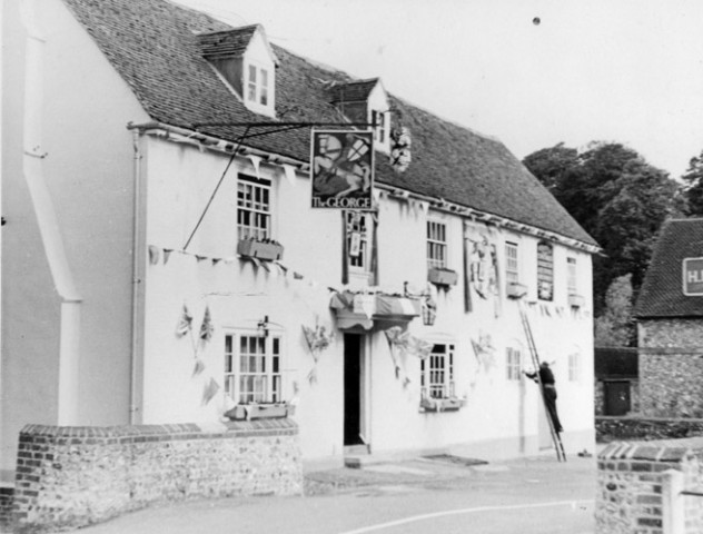 The George Inn - bunting being put up.