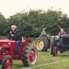 Parade of vintage tractors at an early Country Fair.