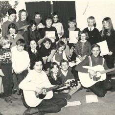 Little Folk group photographed in February 1969. Back row – left to right: Valerie Mason, Sharon Sykes, Bridget Lambert, Selina Kelly. Second row from the back – left to right: Ian Berry, Joanna Nott, Prue Nott, Teresa Berry, Steven Hoare, Gary Sykes, Linda Jaquillard. Next row: Duncan Traill, Andrew Nott, Katie Burley, Brigitte Jaquillard, Kim Sparrow,   Julie Goddard, Fiona Trail Front row: Dixie Nott, Gillian Berry, Robert Matthews, Nigel Lambert.