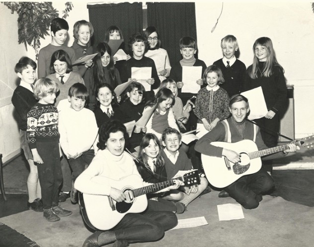 Little Folk group photographed in February 1969. Back row – left to right: Valerie Mason, Sharon Sykes, Bridget Lambert, Selina Kelly. Second row from the back – left to right: Ian Berry, Joanna Nott, Prue Nott, Teresa Berry, Steven Hoare, Gary Sykes, Linda Jaquillard. Next row: Duncan Traill, Andrew Nott, Katie Burley, Brigitte Jaquillard, Kim Sparrow,   Julie Goddard, Fiona Trail Front row: Dixie Nott, Gillian Berry, Robert Matthews, Nigel Lambert.