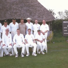 Cricket team on tour in Chumleigh and scoreboard. Back row L to R, Richard Dampney, Melvyn, n.k., Rob Thorne, Peter Suart, Chris Warren. Front row, n.k., Alastair Wheeler, Jeff Wheeler, Simon Edsall, Alan Blackman.