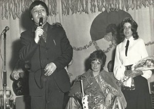 John Sparow announces Jenny Wheeler as Queen, with attendant Diana Adams