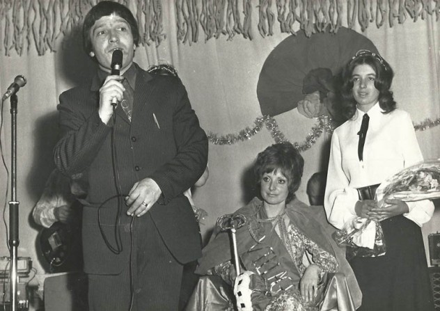 John Sparow announces Jenny Wheeler as Queen, with attendant Diana Adams