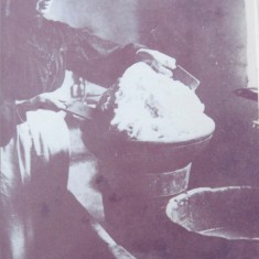 Lady-making-butter copy Jane Wren, wife of the farmer at Riplington, works butter to remove buttermilk, 1908 - 1910