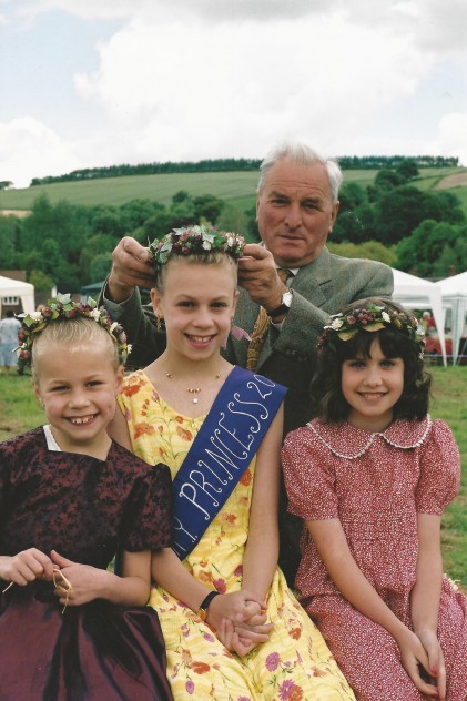 Wilson Atkinson crowns Emily Cross as May Queen, with her sister Amy in attendance (left)