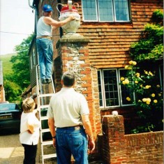 Placing Coronation decorations at Goddard's garage.