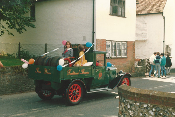Decorated truck in procession past Bell Cottage