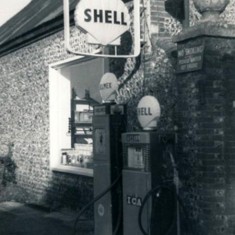 Petrol pump outside garage,.