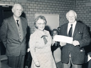 Herbie Goddard receives certificate from his successor, Betty Tucker, March 1981.