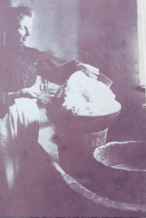 Jane Wren, working butter by hand at Riplington Farm, c 1908