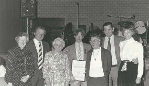 Presentation by Atkinsons to farm hand Ginger Phillips. L to R, Eileen A, Wilson A, Sarah (Wilson's mother), Ginger Phillips with certificate, Kate, Michael and Jane Atkinson 