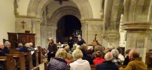 Audience settling The History Group taking their seats in All Saints Church before the talk given by Michael Blakstad in October 2017