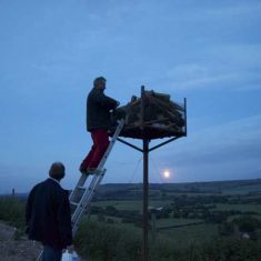Bill Tyrwhitt Drake about to light the beacon
