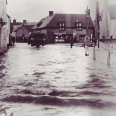 Flooded High Street with tractor Flooding in the High Street, 17th November 1957.