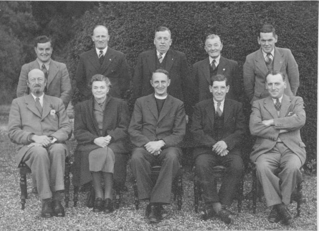 Seated in the Committee photograph are: Lady Margaret Nicholson, the last of the Nicholson ‘Gin’ family to live at Bereleigh, (sitting second left) was reported to be a very strong lady in her own right and could get her own way, and saw that the Village Institute & Library was well run.  Others  were, (from left to right back row), W (Weary) Blackman from Drayton who worked at Bereleigh Estate on the farm side, Herbert (Herbie) Goddard who ran the garage and petrol pump from the yard of Glenthorne House. Jack Porter who was the caretaker and Librarian and worked for the Ministry of Defence at Liphook.  He was brother-in-law to Iris Porter.  Frank Collyer, leader of the Home Guard and father of Margaret Tosdevine.  He was a wood turner by trade. Finally, standing at the end of the row Rece Porter (husband to Iris).  He was a Postman and assisted his brother looking after the Institute.