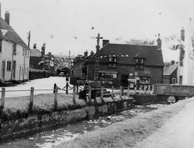 River, Pinks store and war memorial covered in bunting for the Coronation of Elizabeth II in June 1953